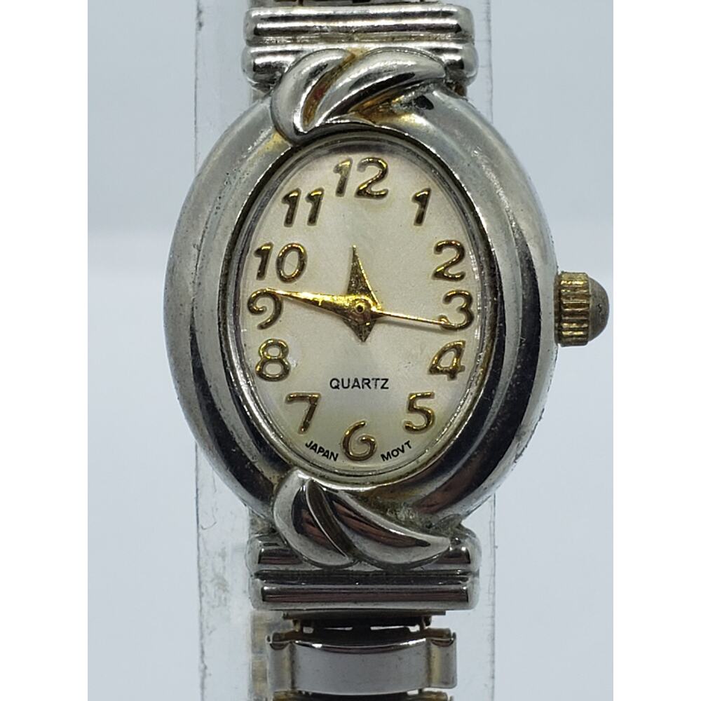 White Stag women's dress watch. Light gold face with unique wave buckle on band